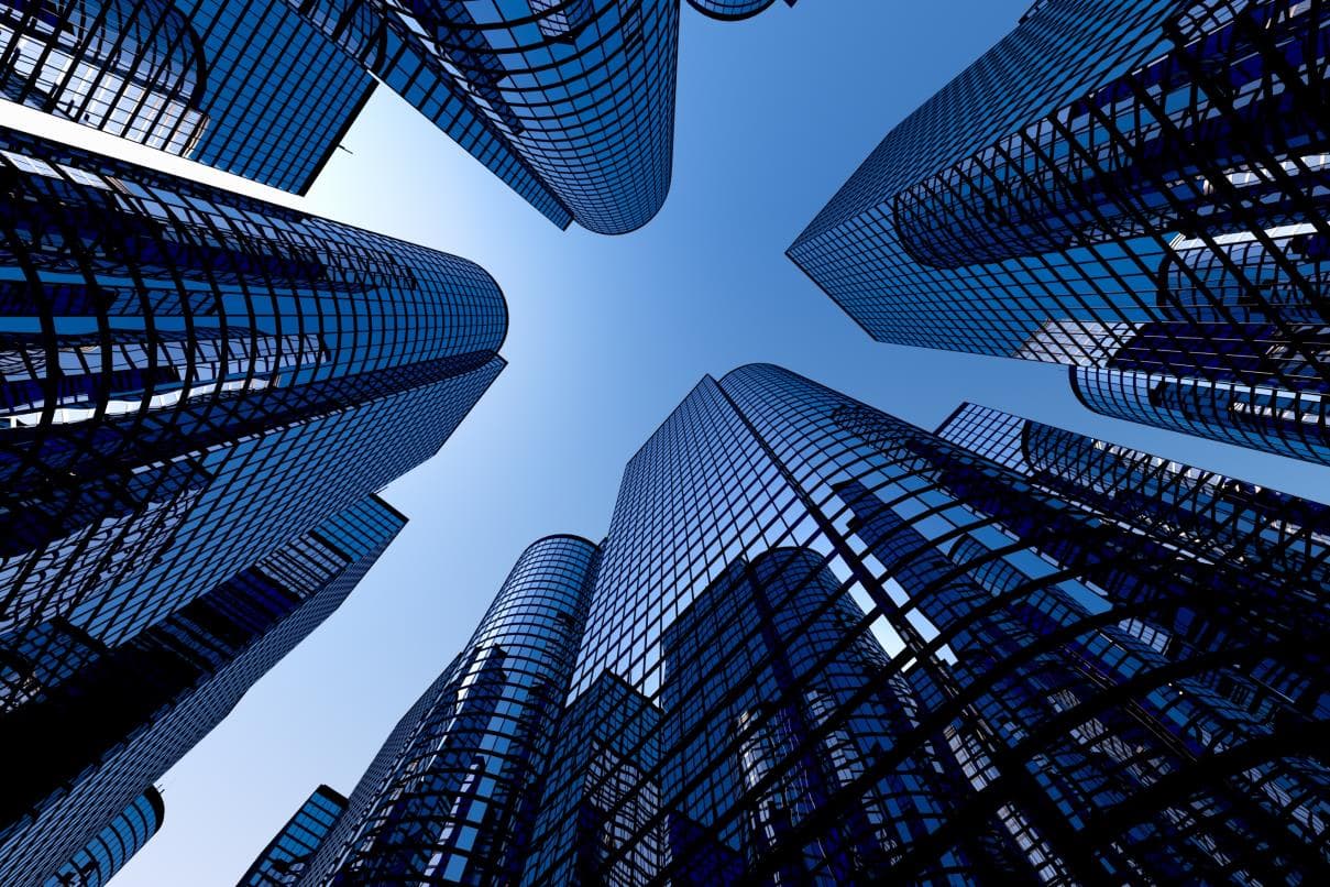 Blue glass office towers photographed from below